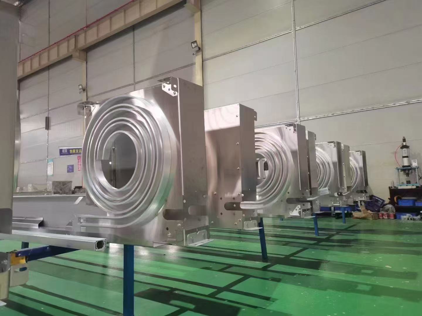 A row of metal turbine rapid-door head assemblies in the workshop